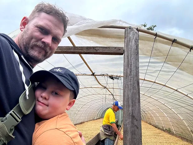A father and son together inside the drying house